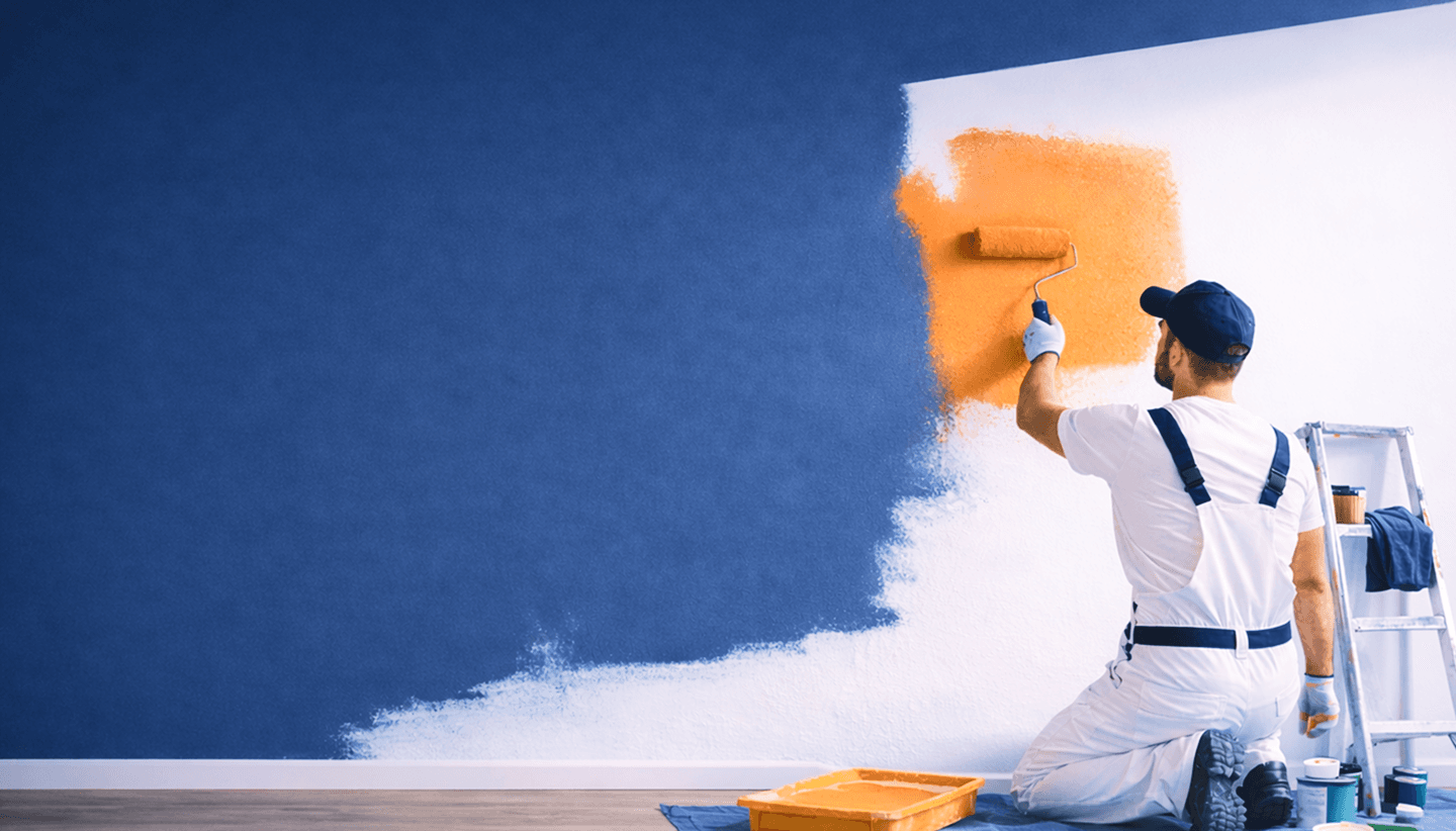 Professional painter painting wall