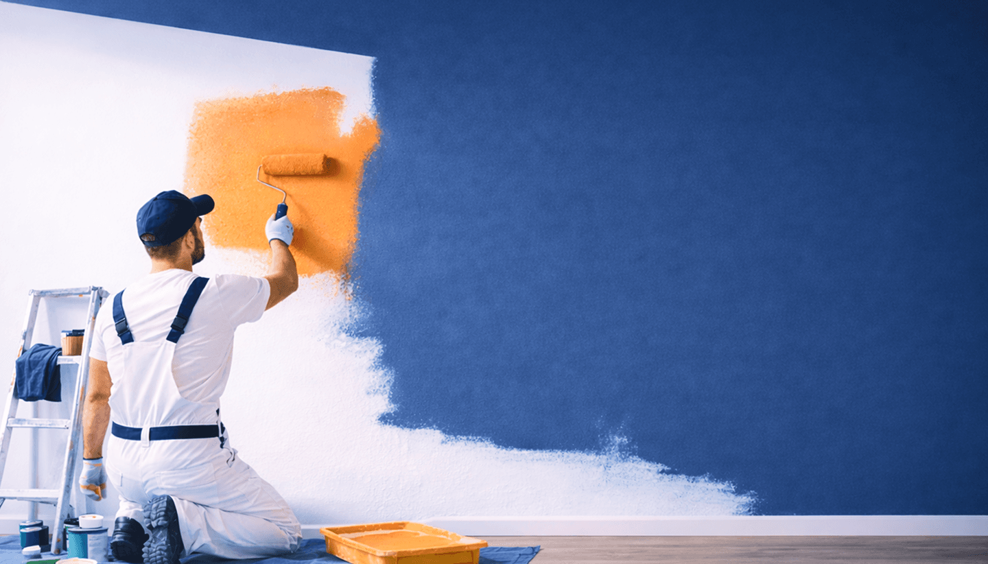 Professional painter painting wall